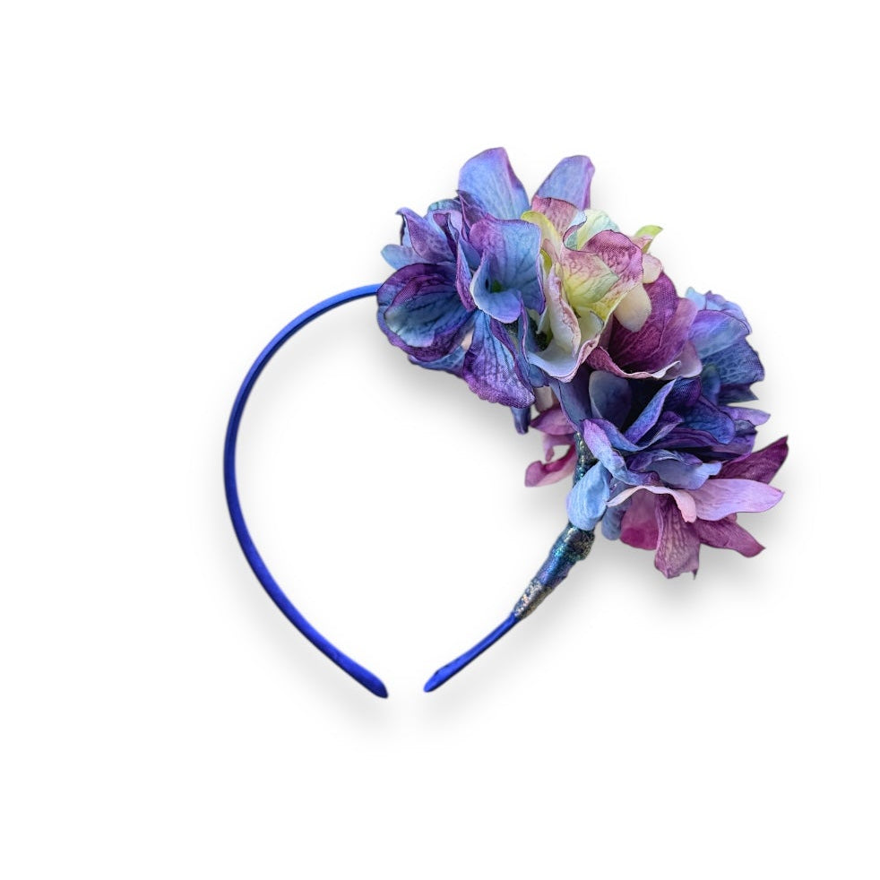 Asymmetrical floral headband, handcrafted with high-quality fabric hydrangeas in a vibrant mix of magenta, blue and soft powder blue tones.