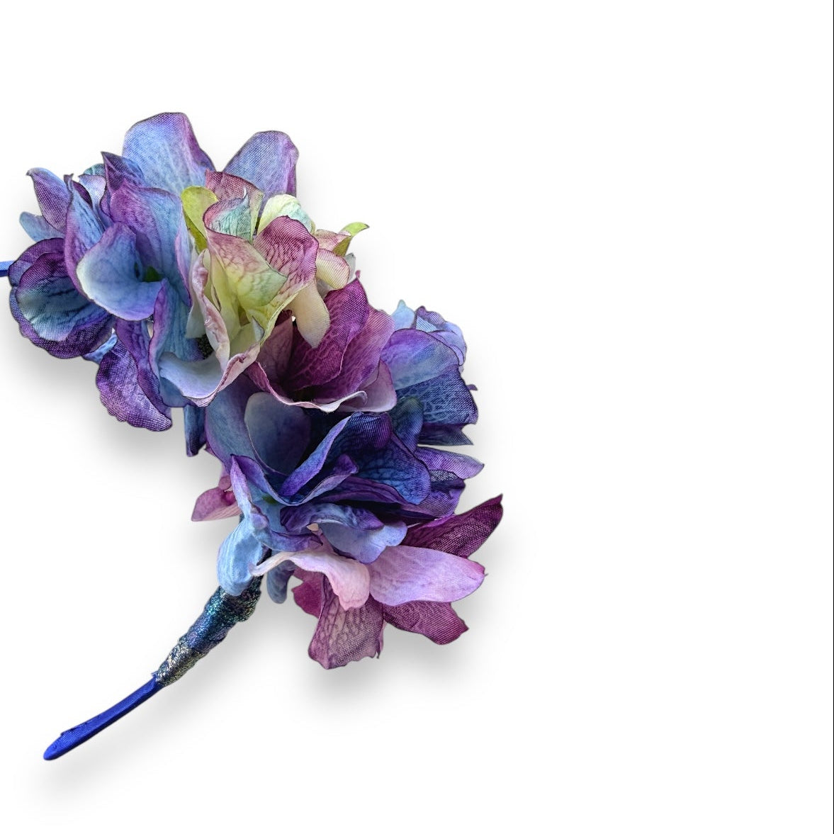Asymmetrical floral headband, handcrafted with high-quality fabric hydrangeas in a vibrant mix of magenta, blue and soft powder blue tones.