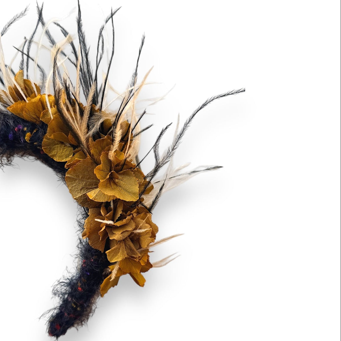 Handcrafted Wild Bloom Black & White headpiece with golden ochre preserved hydrangeas, black and white ostrich feathers and a white fabric-covered headband.