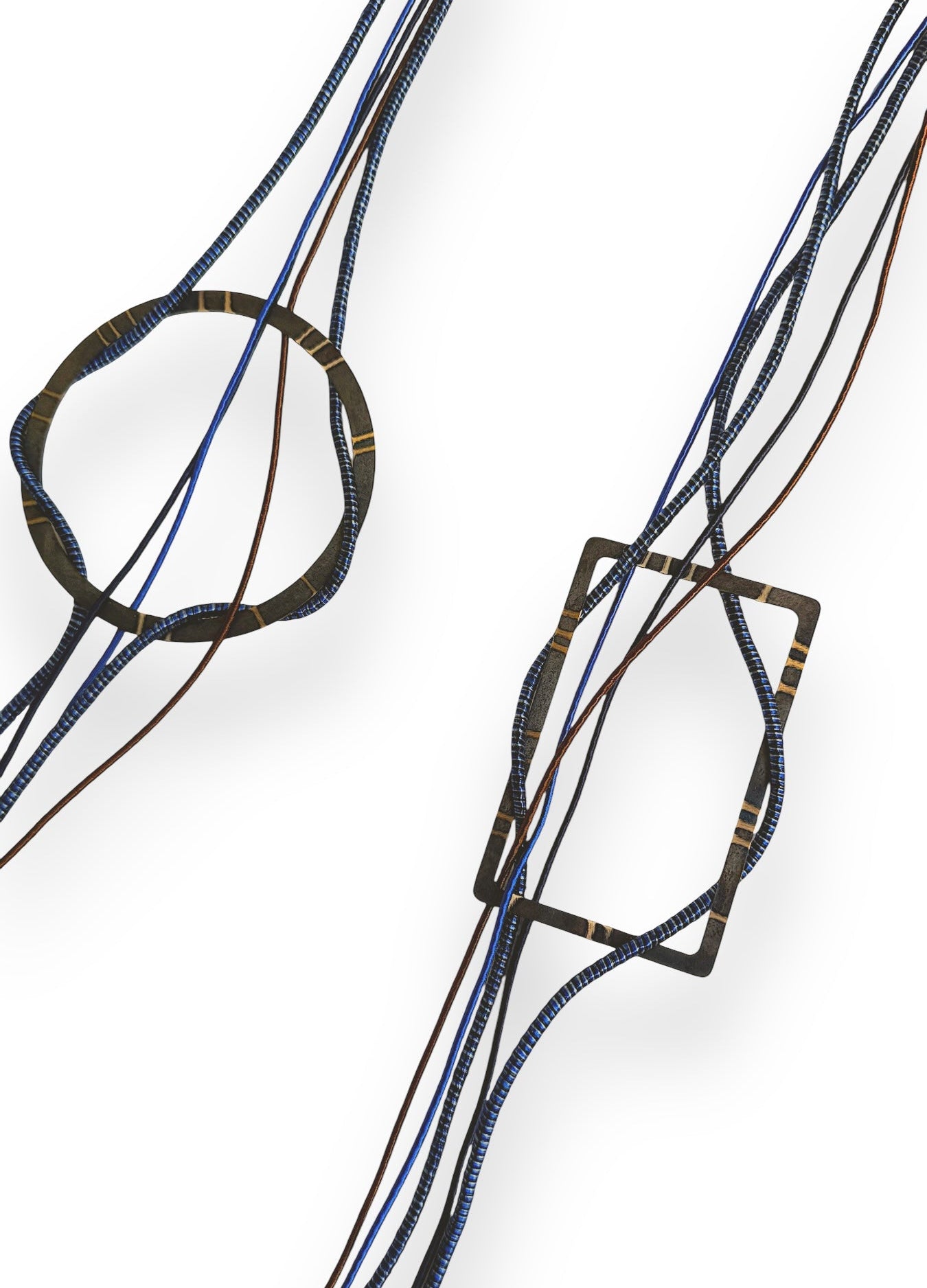 Close-up of a necklace with interwoven blue and black strings on a white background