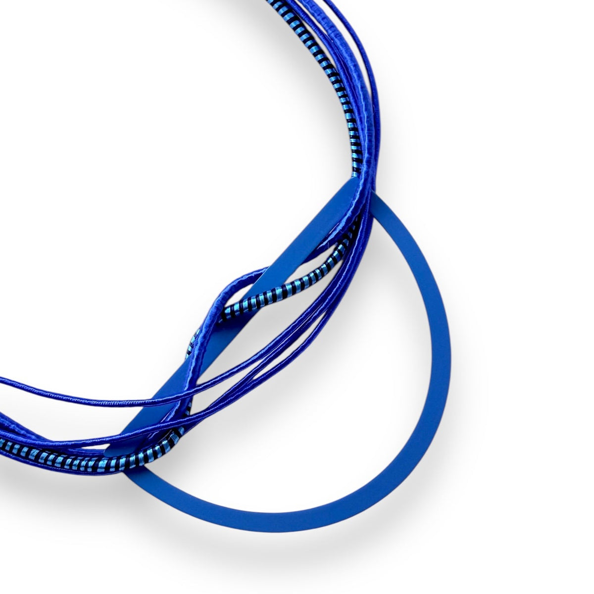 Handmade electric blue fabric bib necklace with silk-wrapped cords, blue powder-coated brass half moon pendant and gold-tone magnetic clasp.