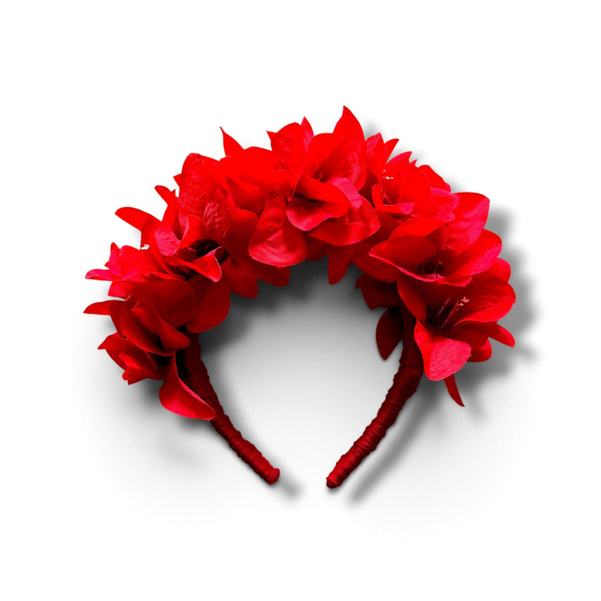 A bright red flower crown headband featuring multiple layered red fabric flowers on a matching red band, shown against a plain white background.