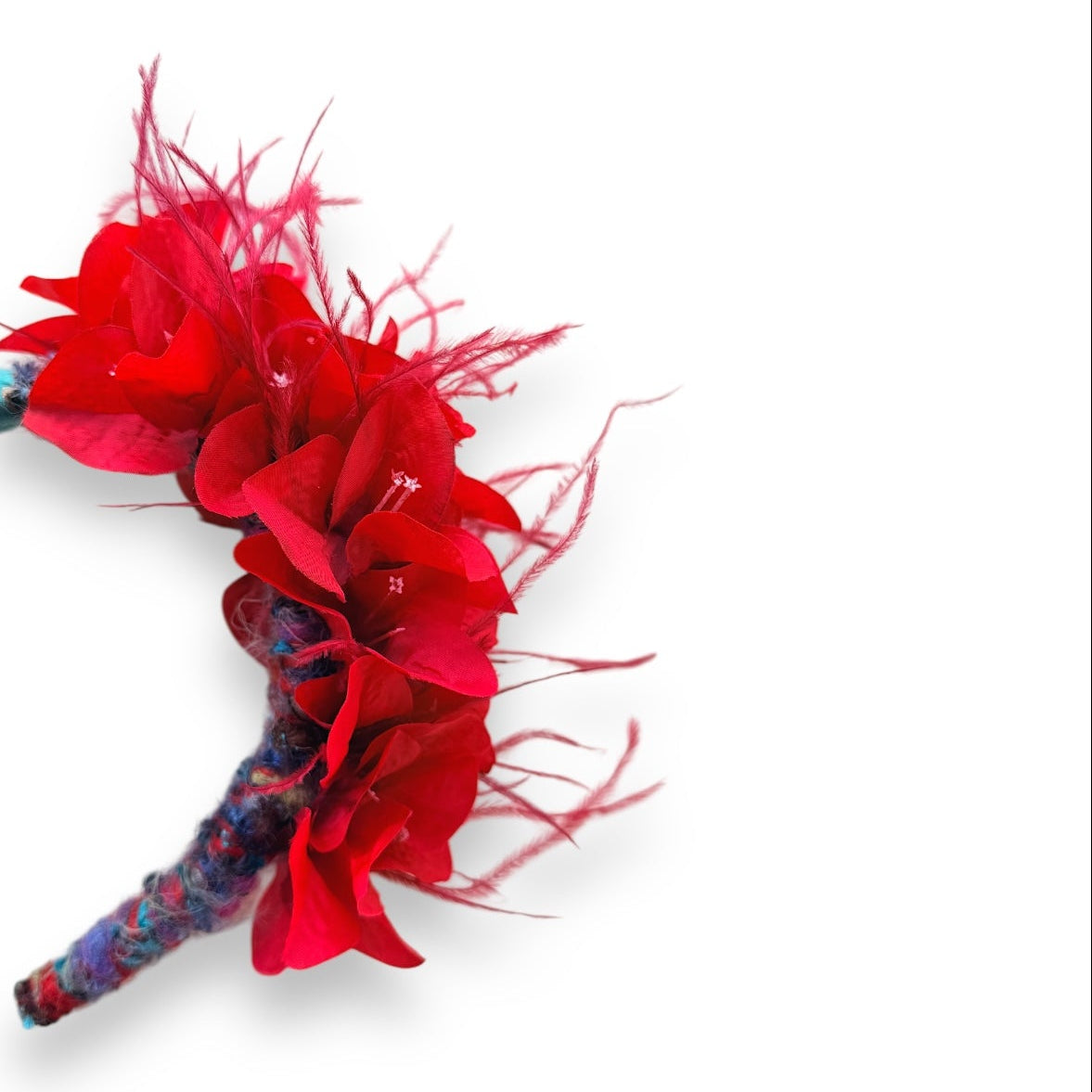 Handcrafted Red Bougainvillea Statement Headband with vivid red fabric flowers, red ostrich feathers, colourful yarn detailing and a turquoise velvet padded headband.